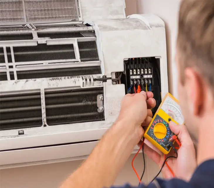 Man testing split system indoor air conditioning unit